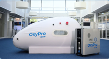 Load image into Gallery viewer, OxyPro CTN oxygen therapy chamber in a modern indoor setting