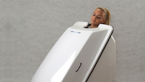 A customer in an ozone therapy unit, an infrared sauna infused with pure oxygen and ozone to help the body detox and heal.